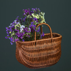 Fototapeta na wymiar Wicker basket with wildflowers