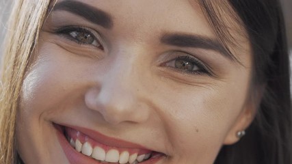 Cropped shot of a beautiful happy woman smiling. Gorgeous cheerful young female smiling to the camera. Portrait of a lovely excited woman. Diversity, women concept