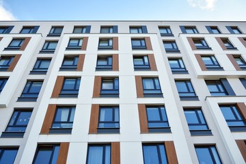 Modern luxury urban apartment building exterior with blue sky