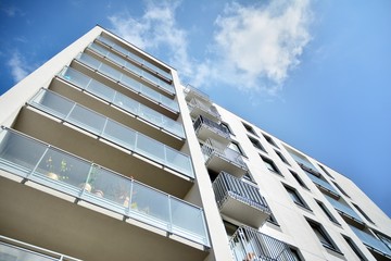 Modern luxury urban apartment building exterior with blue sky