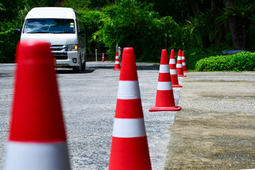Traffic cones are arranged on the street. The back of the car is white on the street or land traffic to ensure safety.
