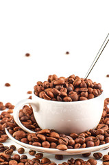 Background of coffee beans and coffee Cup with saucer isolated on white background.