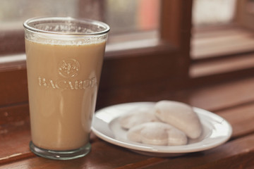 cup of coffee and cookies on wooden table