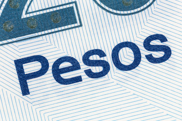 Macro close up detail of the word Pesos on Mexican currency.