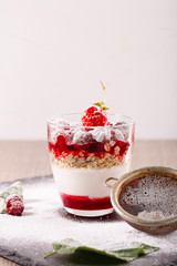 delicious dessert of fresh raspberries and strawberries with oatmeal in a glass glass. Verin.