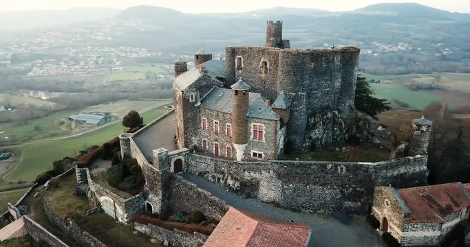 Aerial view of impressive medieval castle of Chateau de Bouzols on hill in commune of Arsac-en-Velay, France
