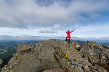 Obraz premium girl athlete on top of the mountain.
