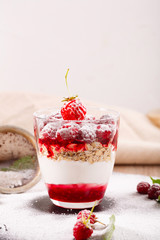 delicious dessert of fresh raspberries and strawberries with oatmeal in a glass glass. Verin.