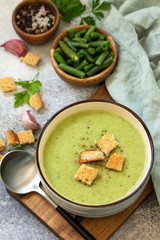 Vegetarian dish. Dietary delicious cream soup of green beans on a light background.