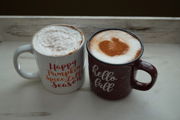 Hot seasonal beverages in mugs on a wooden tray