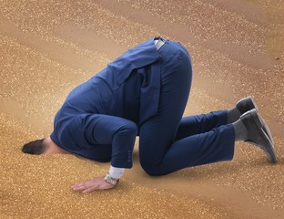 Businessman hiding his head in sand escaping from problems