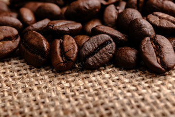 Coffee beans on burlap background