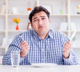 Man on diet waiting for food in restaurant
