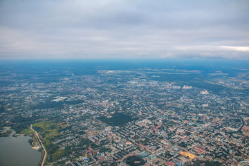Top view of evening city in fog and reservoir