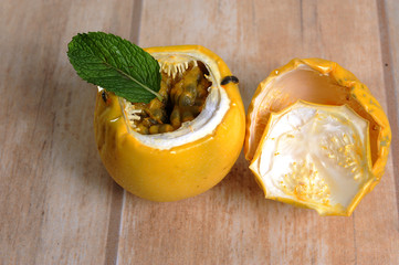 Passiflora edulis is a semi-woody climbing plant. Popularly known as passion fruit. Native to southeastern Brazil. Great natural calming. Light background. View from the top. Horizontal.