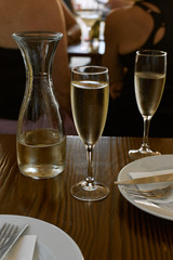 Sparkling wine in two glasses and in a jar