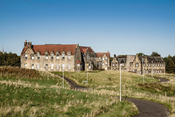 Fototapeta na wymiar A view towards Villa 20; Bangour Village Hospital; Dechmont, near Livingston, Scotland. The site has been unused since the last patients in 2004.