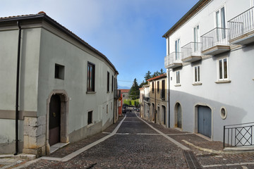 Fototapeta na wymiar Frigento, Italy, 09/28/2019. A narrow street among old buildings of a mountain village.