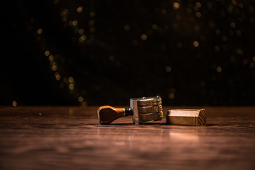 Close up view of rubber date stamper on wooden table with dark toned foggy background.