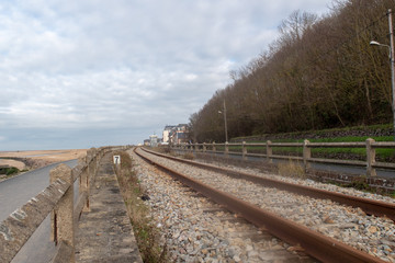 Fototapeta na wymiar The railway between Houlgate and Cabourg, on a grey winter day. Nice perspective.