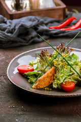 salad with salmon on dark table