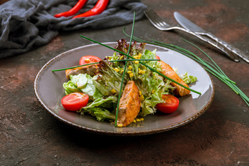 salad with salmon on dark table