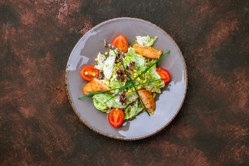 salad with salmon on dark table