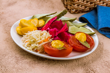 plate of pickles on rustic table