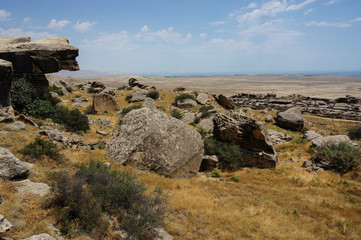 Fototapeta na wymiar boulders in the desert landscape of Gobustan national Park in Azerbaijan