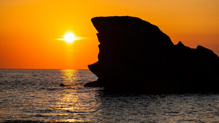 Sunset beyond the rock