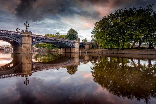 Skeldergate Bridge in the City of York, Yorkshire England. Reflections of the bridge are on the water and the time of day is sunset