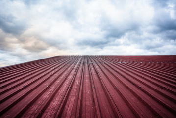 A red roof of corrugated steel pointing to the sky