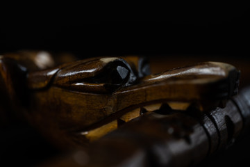 Snake made of wood on a black background