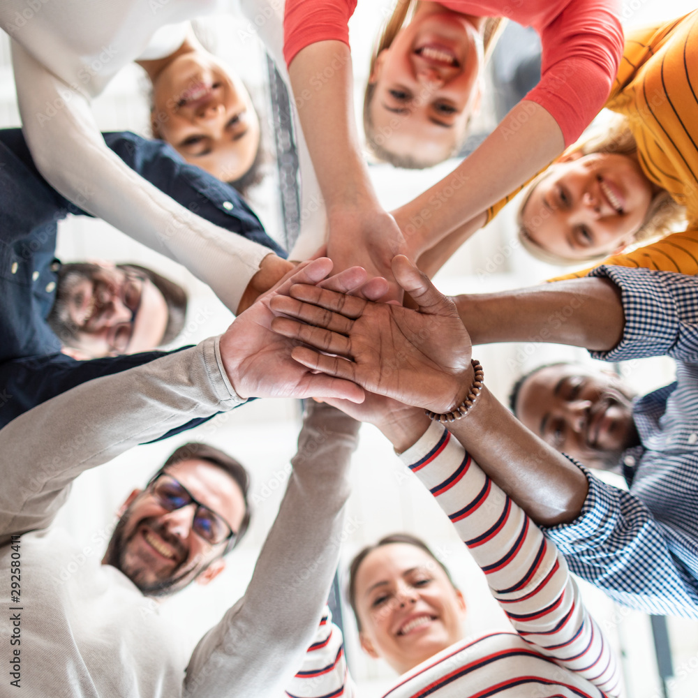 Wall mural stack of hands. unity and teamwork concept.