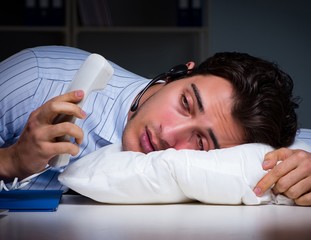 Tired and exhausted helpdesk operator during night shift