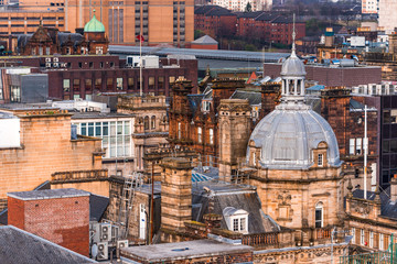 A rooftop view of the mixed architecture of old and new buildings in Glasgow city in evening light, Scotland