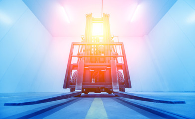 Forklift in a large industrial freezer warehouse. Empty warehouse for vegetable storage.
