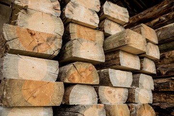 Stack of natural rough wooden boards. Wooden boards, lumber, industrial wood.