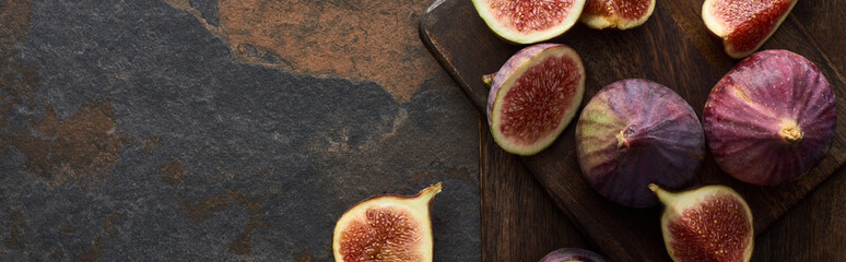 top view of figs and wooden cutting boards on stone background, panoramic shot