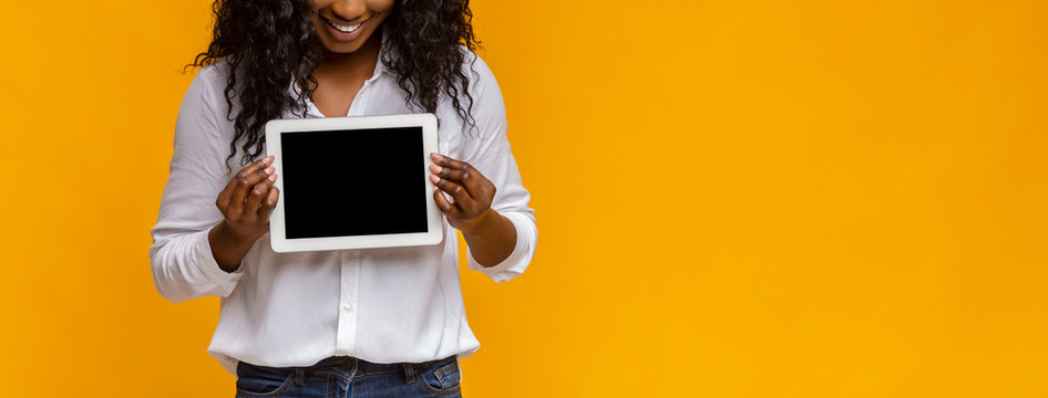 Cropped image of black girl showing empty digital tablet screen
