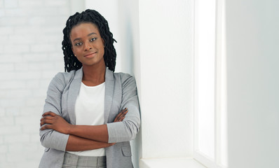 Young Black Lady Looking At Camera Standing In Office - obrazy, fototapety, plakaty