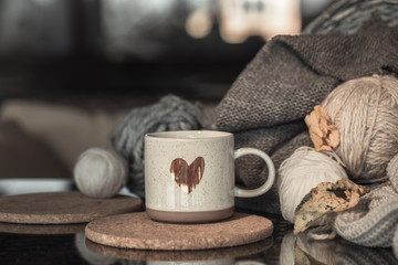 Cozy Autumn background with a beautiful Cup with a heart.
