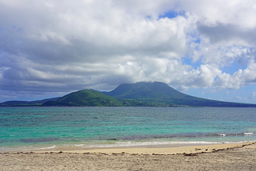 Fototapeta na wymiar Day view of the Nevis Peak volcano across the water from St Kitts