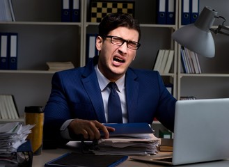 Employee working late to finish important deliverable task