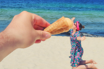 Comical photo - man feeds ice cream to a woman on the beach, fun
