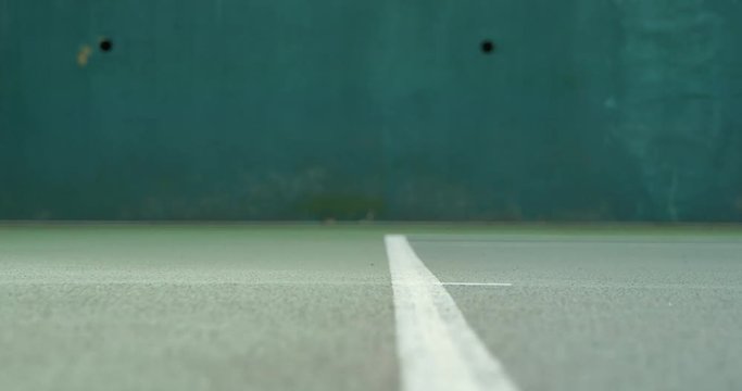Close up action of a tennis serve in slow motion.