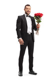 Man in a suit holding a bunch of red roses