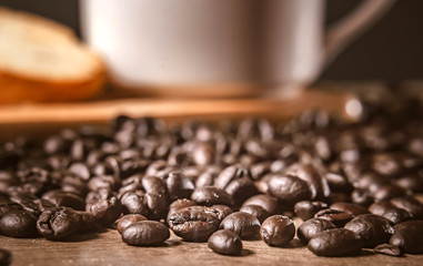 Coffee on wooden background. Brown roasted coffee beans, seed on dark background. Espresso dark,...