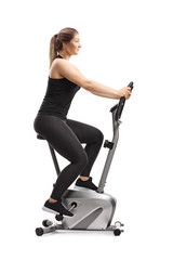 Young woman riding a stationary bike