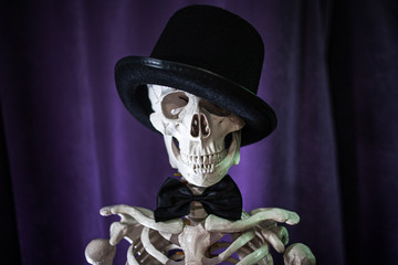 Funny human skeleton in a bowler hat.